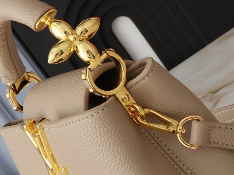 【AT2575】このLV Capucinesミニハンドバッグは、ハンドルに繊細なモノグラムの花柄が取り入れられており、立体的なLVロゴを繊細なタッチで表現しています。柔らかなデザインに鮮やかな輝きを与えています。