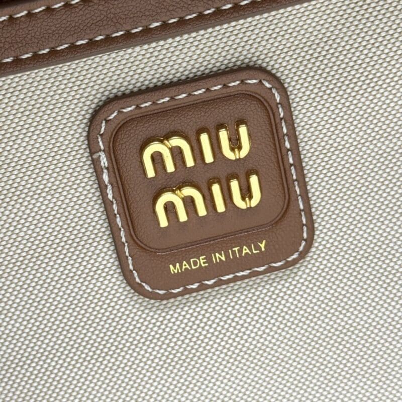 【AT8786】Miu Miuのストライプビジネスバッグ - クリーム色のカーフスキン素材で都会的なエレガンスを演出 | Miu Miu